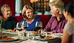 Smiling people enjoying their meal in restaurant