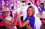 Women wearing hats dancing at bachelorette party