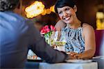 Mature couple holding hands at restaurant table