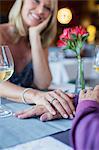 Couple holding hands in restaurant