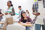 Students writing their GCSE exam in classroom