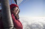 Woman travelling in a hot air balloon.