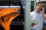 Computer technician performing maintenance check of mainframe equipment