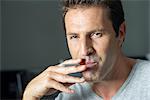 Man smoking electonic cigarette, portrait