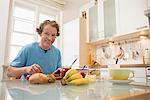 Smiling man sitting at breakfast table in kitchen