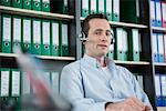 Portrait young man sitting office headset
