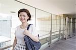 A woman on a walkway in Namba Park office and shopping complex.