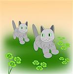 Two little cats playing on a clover meadow.