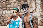 Pair of handsome male cirque performers outside