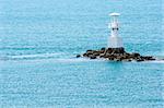 White Lighthouse on the sea and blue sky in Thailand