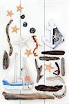Abstract collage of seaside and beach related objects over wooden white background.