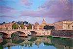 View of Vittorio Emanuele Bridge and the St. Peter's cathedral in Rome, Italy during beautiful sunrise.