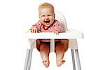 Portrait of baby with dirty mouth after eating. Baby sitting on chair.