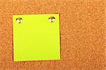 Note paper with pin on cork board. Stock photo