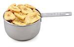 Dried banana chips in an American cup measure, isolated on a white background