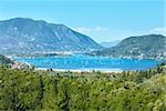 Many sailing vessels in bay. Hazy summer Lefkada coast landscape (Nydri, Greece, Ionian Sea).