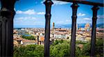 Florence panoramic view with Cathedral Santa Maria del Fiore, Pallazo Vecchio and Ponte Vecchio seen trough a fence, Italy