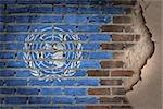 Dark brick wall texture with plaster - flag painted on wall - United Nations