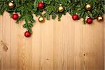 Christmas background with fresh firtree and  baubles on wood - horizontal