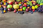 Big assortment of Fresh Organic Fruits, border composition on wooden table