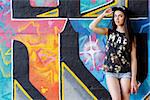 Street, outdoor. Attractive teen in a cap