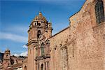 Red granite walls of the historic Iglesia La Merced located close to the Plaza de Armas in Cusco, Peru. The church was founded in 1535 and was constructed shortly after the Spanish conquest of the Inca Empire.