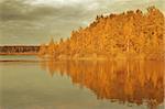 Autumn landscape. Lake evening view with island and rainy sky.