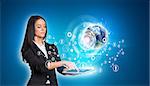 Beautiful businesswomen in suit using digital tablet. Earth with graphs and network. Element of this image furnished by NASA