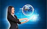 Beautiful businesswomen in suit using digital tablet. Earth with transparent rectangles, graphs and network. Element of this image furnished by NASA