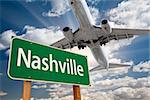 Nashville Green Road Sign and Airplane Above with Dramatic Blue Sky and Clouds.