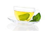 Mint tea with fresh peppermint leaves in transparent glass teacup isolated on white background with clipping path. Healthy tea drinking.