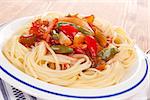 Culinary pasta with fresh vegetables on white plate. Delicious asian cuisine.
