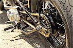motorcycle wheel and drive-chain with golden toned hightlights
