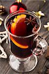 Glass of mulled wine with orange and spices