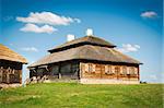 Beautiful landscape with restored old style russian farmhouse with thatch roof