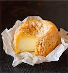 French cheese Langres on an old wooden background.