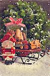 Christmas decoration with decorative nutcracker and sweet cookie in glass bell jar on a sled. Vintage style. Toned photo.