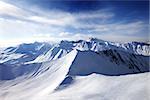 Off-piste slope and sunlight sky. Caucasus Mountains, Georgia, ski resort Gudauri. Wide angle view.