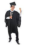 Full length happy southeast Asian university student in graduation gown, standing isolated on white background.