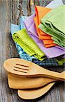 Arrangement of Multi Colored Cloth Napkins and Kitchen Spoons isolated on Rustic Wooden background