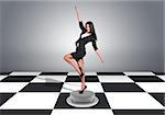 Beautiful businesswoman posing and looking into camera. Floor with checkerboard texture and gray wall