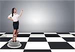 Beautiful businesswomen in blouse and skirt standing and pushing an imaginary buttons. Floor with checkerboard texture and gray wall