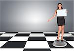 Beautiful businesswomen in dress holding empty paper. Floor with checkerboard texture and gray wall