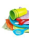 Stack of Multi Colored Cloth Napkins with Plastic Plates, Spoons and Cups isolated on White background