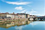 Image of houses, river Arno and ponte Vecchio in Florence, Italy in autumn on a sunny day