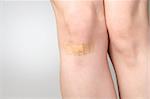 Female leg with adhesive bandage