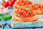 Italian tomato bruschetta with basil and oil on toasted crusty bread