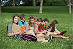 Happy group of male and female teens studying