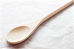 Wooden spoon on baking paper, stock photo