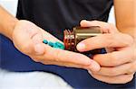 a young man with a bottle of pills in his hands